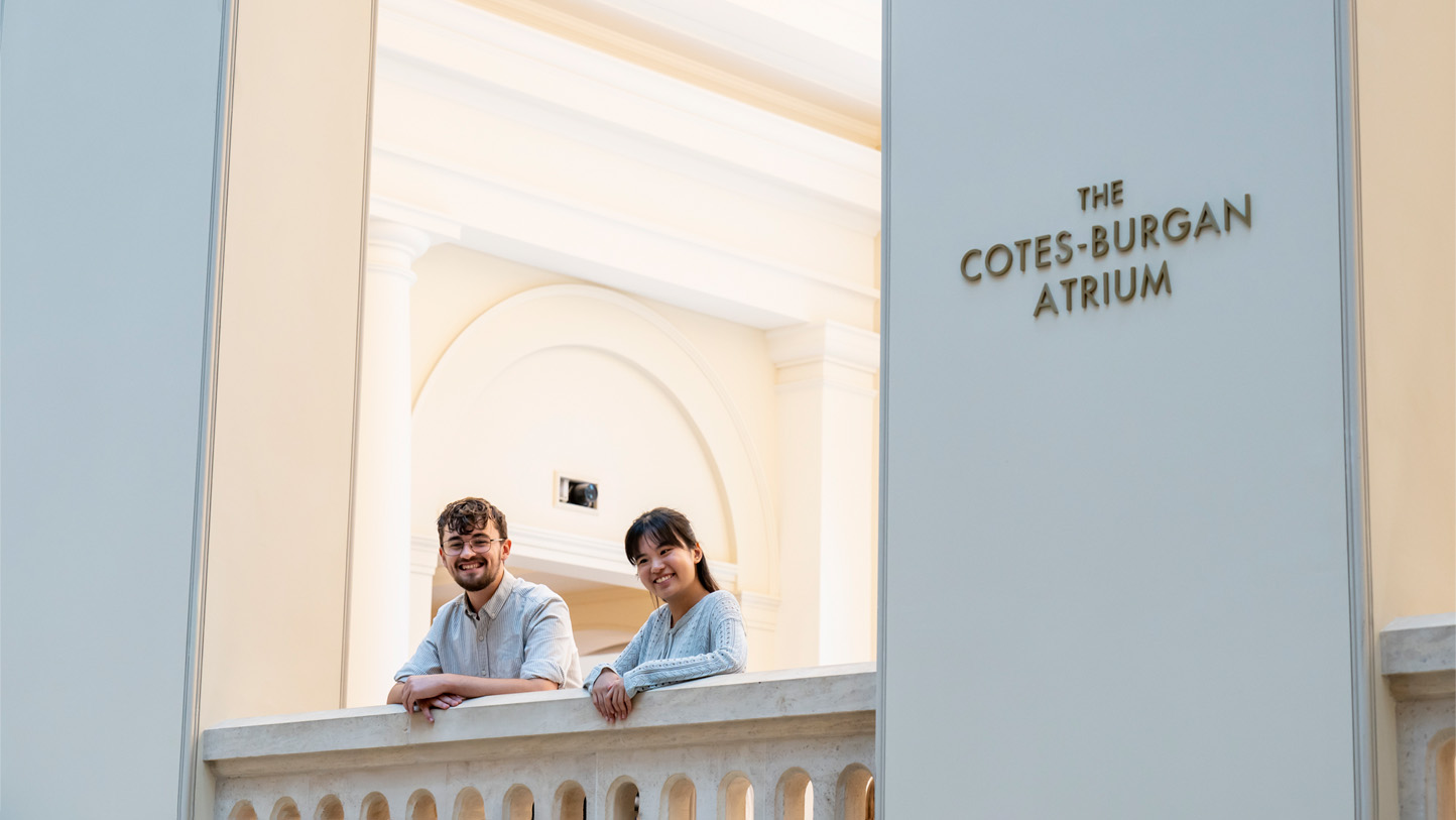 Two people at the RCM looking out over the new atrium